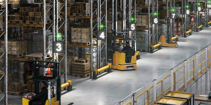 Warehouse with forklift trucks, rack protection and pedestrian barriers.