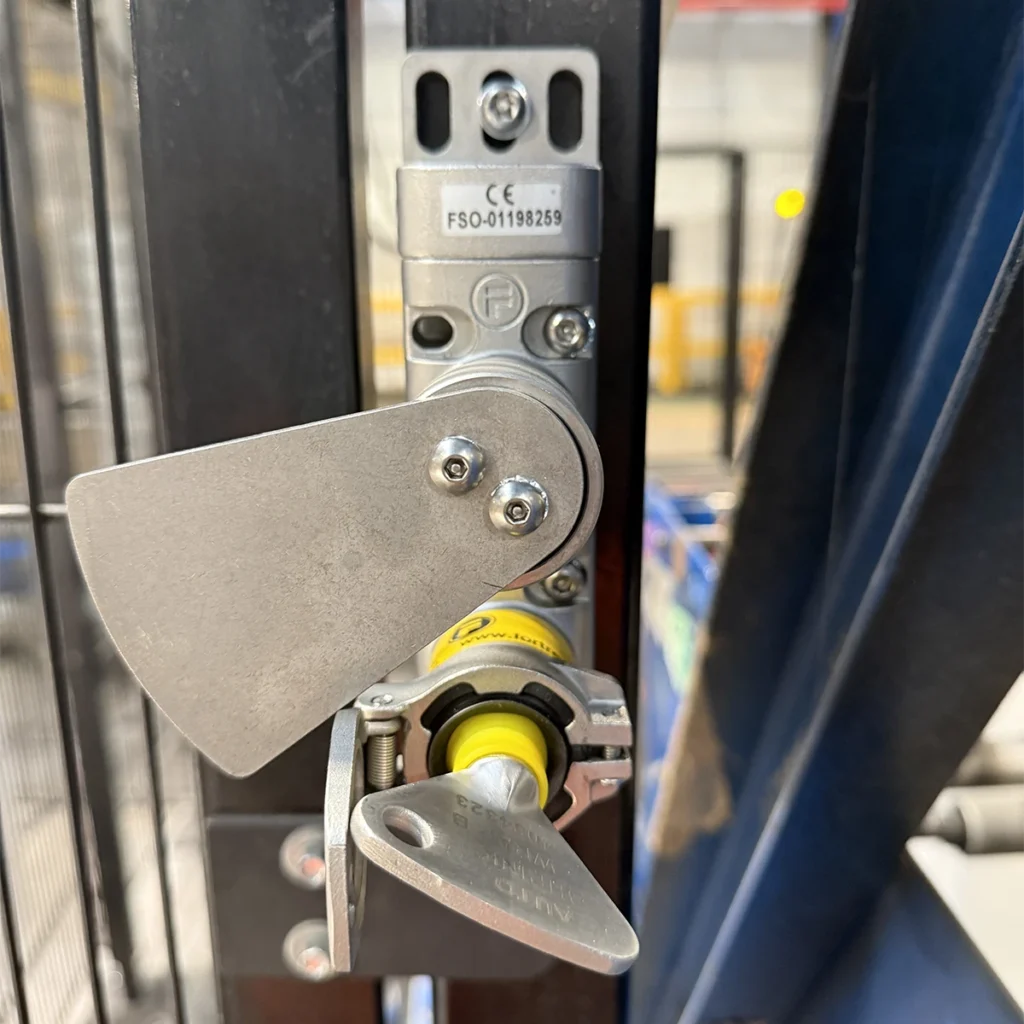 Close-up view of trapped key blocking devices fitted to palletiser guard interlocks